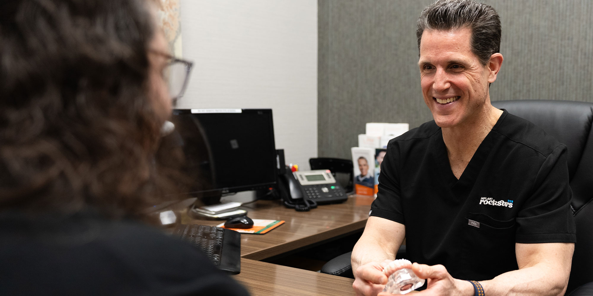 doctor going over dental implant warranty