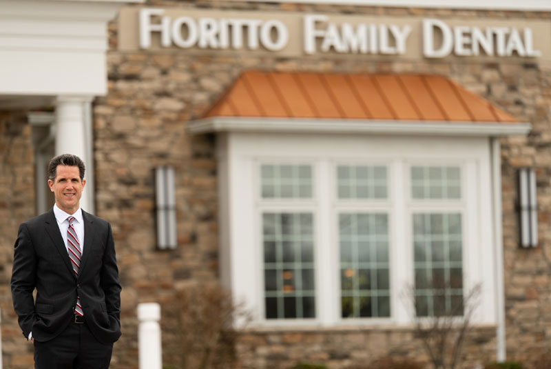 Dr. Michael Fioritto. standing in front of his dental office