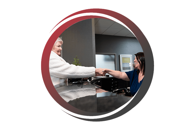 Patient and team member shaking hands talking