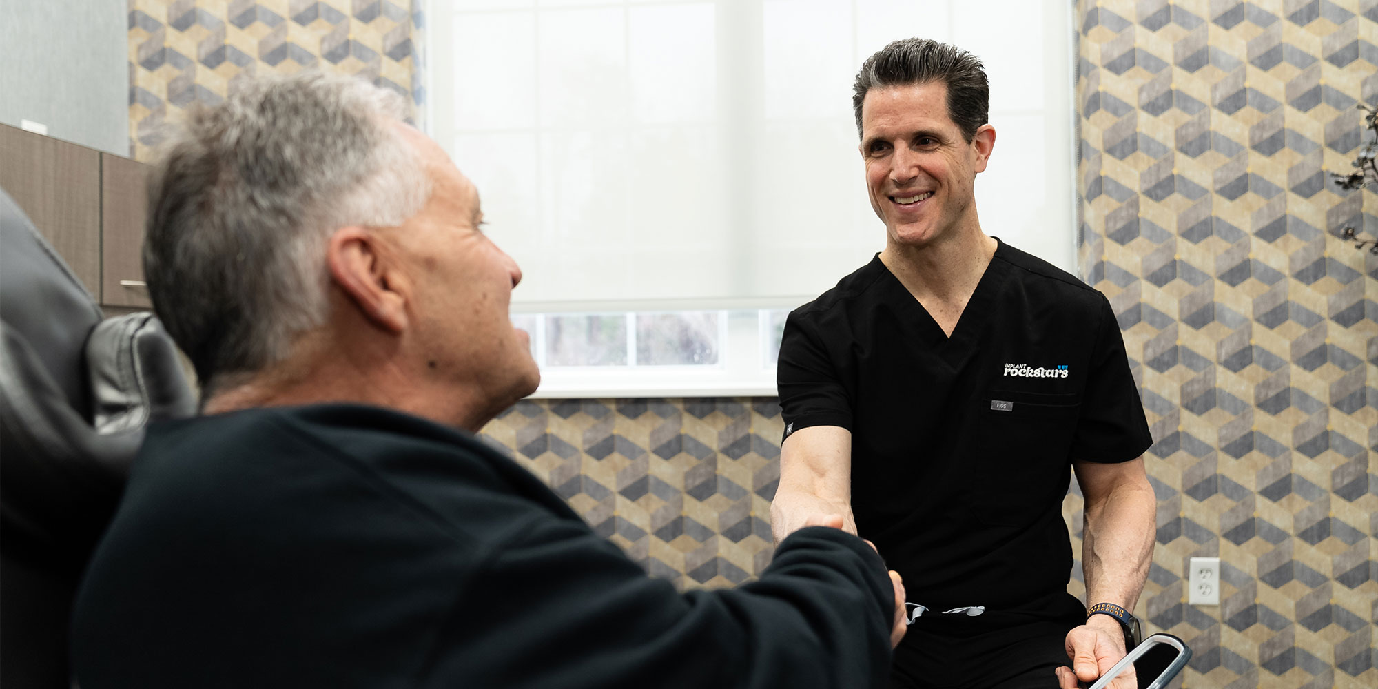 doctor consulting with patients shaking his hand