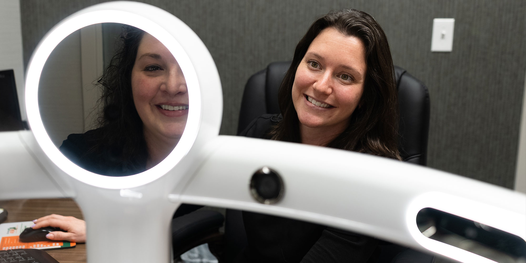 team member taking a scan of patients teeth and face