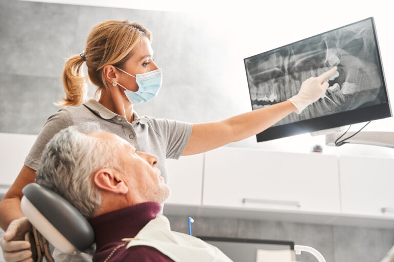 Close up animated image of the parts of a dental implant, explicitly showing the titanium implant, abutment, and crown and how they connect. No text on image.
