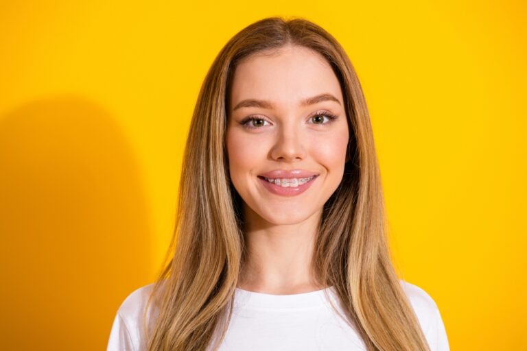 A person with a full smile of perfectly aligned white teeth smiles brightly. The text overlay states "Fake Teeth Options: What's Right for You?"